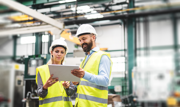 Two people working at a factory